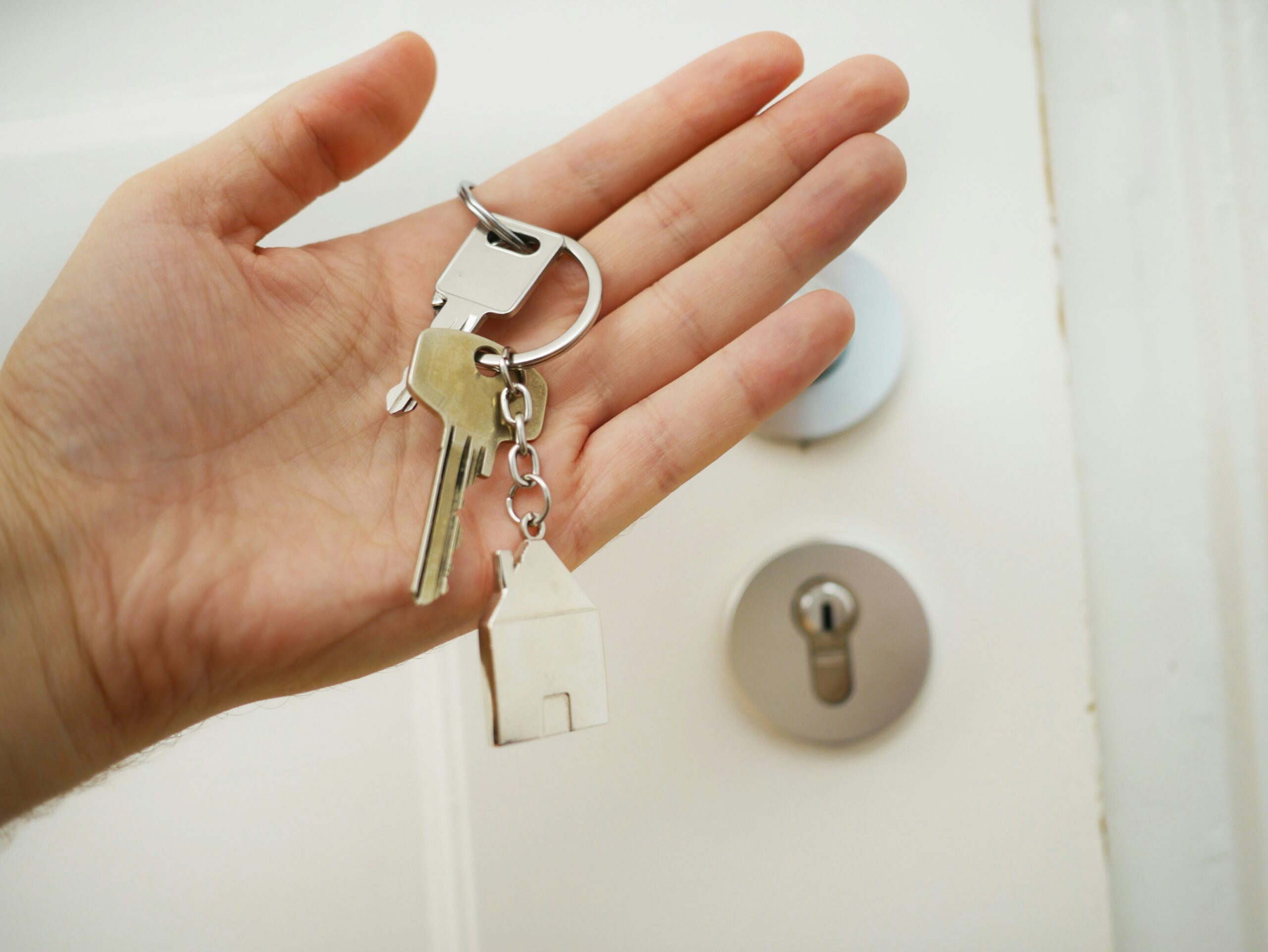 Buying Your First Home in 2025. Woman holding new keys.